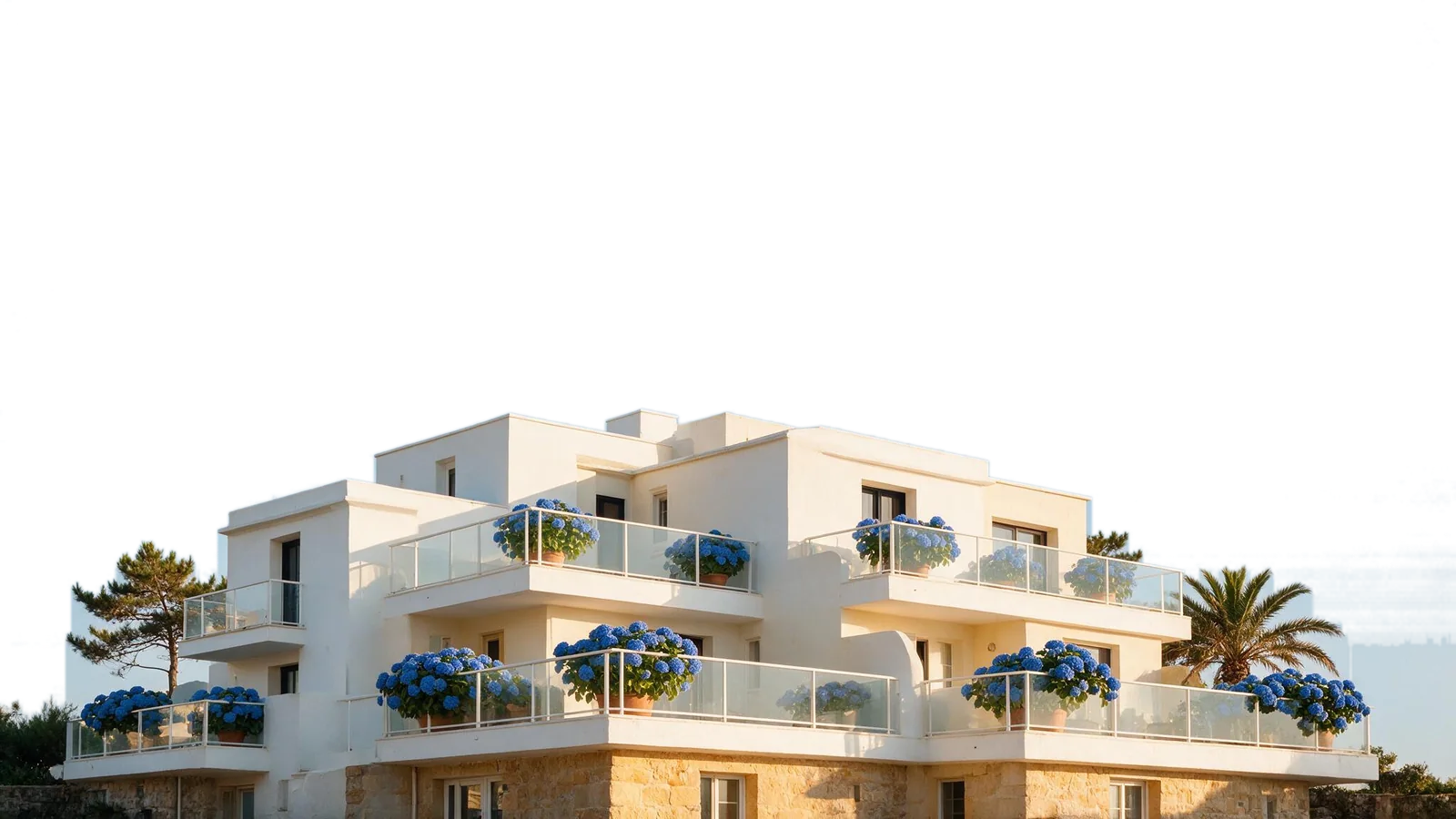 La residencia OLATU vista desde abajo: terrazas escalonadas con hortensias azules bajo un cielo despejado