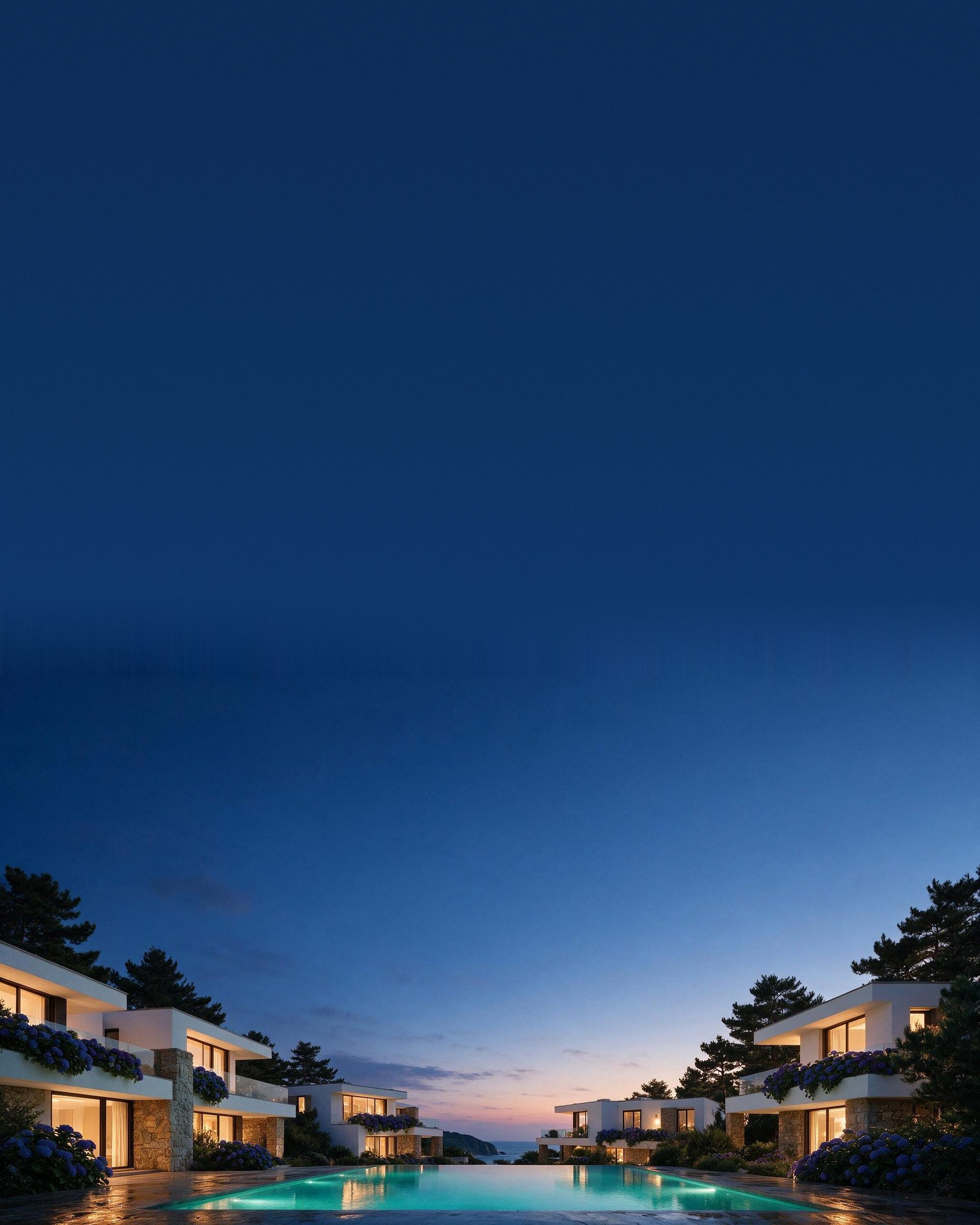 La misma residencia al atardecer, con las ventanas iluminadas